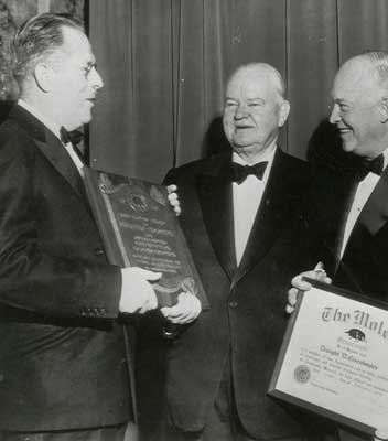 Herbert Hoover is presented with an award for public service and contributions to construction by the Moles.